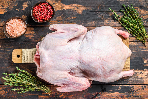 istock Raw whole duck.  Dark wooden background. Top view 1264627945