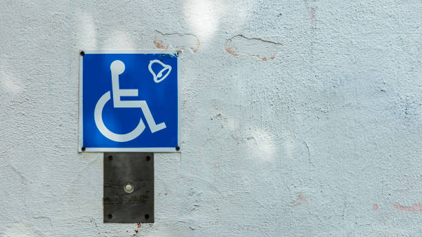 istock sign rise for the disabled on a white wall 1264632120