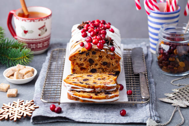 istock Christmas fruit cake, loaf on cooling rack with cup of tea. Grey background. Close up. 1264633184