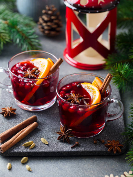 istock Mulled red wine with spices. Christmas decoration. Grey stone background. Close up. 1264633455