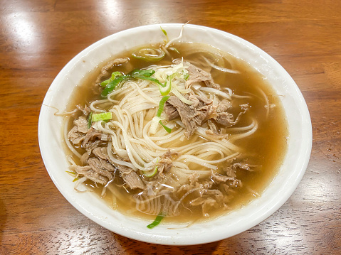 Beef noodle soup on wooden table