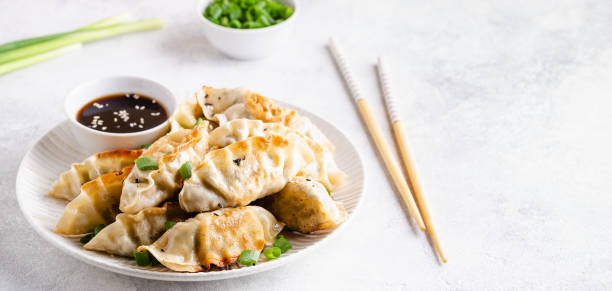 istock Fried dumplings gyoza with soy sauce, and chopsticks, selective focus 1264639370