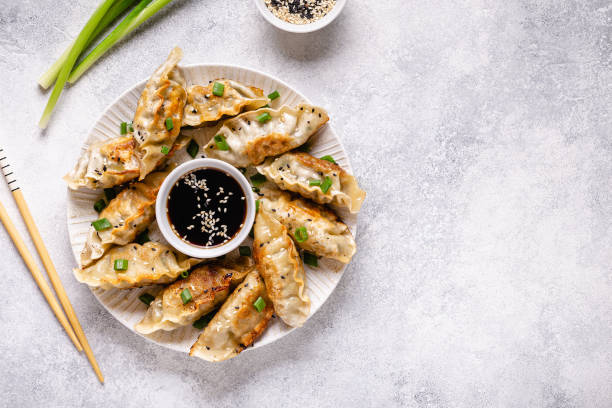 istock Fried dumplings gyoza with soy sauce, and chopsticks, top view 1264639491