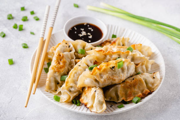 istock Fried dumplings gyoza with soy sauce, and chopsticks, selective focus 1264639497