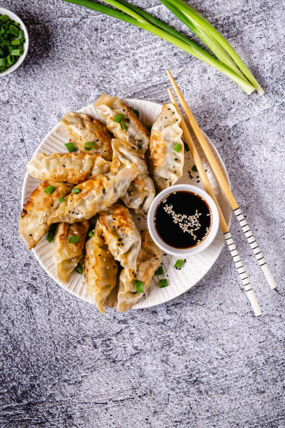 istock Fried dumplings gyoza with soy sauce, and chopsticks, top view 1264639520