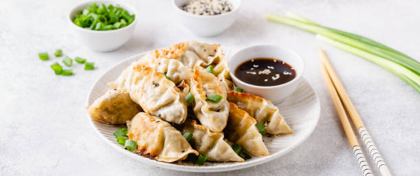 istock Fried dumplings gyoza with soy sauce, and chopsticks, selective focus 1264639543