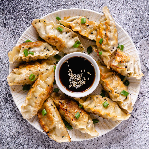 istock Fried dumplings gyoza with soy sauce, and chopsticks, top view 1264639549