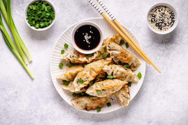 istock Fried dumplings gyoza with soy sauce, and chopsticks, top view 1264639942