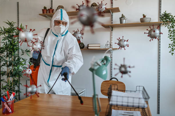 istock Man in protective suit disinfecting covid-19 molecules 1264640499
