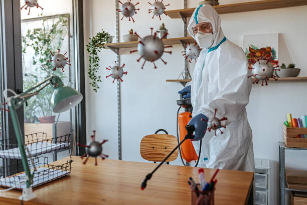 istock Man in protective suit disinfecting covid-19 molecules 1264640507