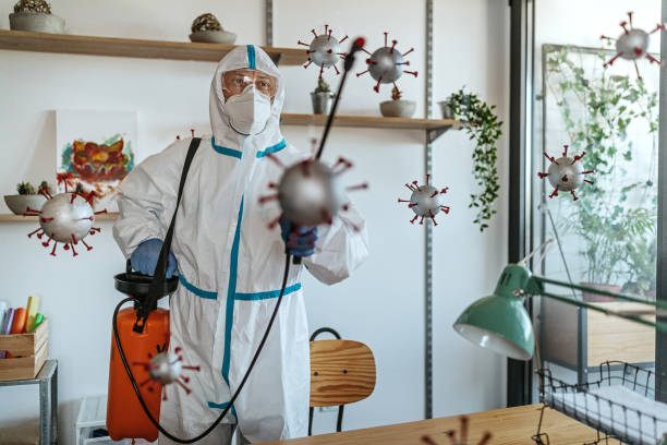 istock Man in protective suit disinfecting covid-19 molecules 1264640509