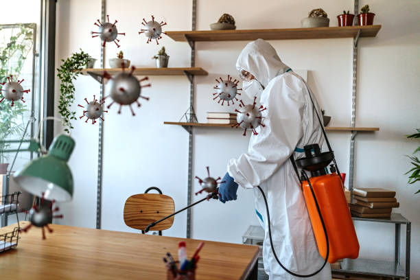 istock Man in protective suit disinfecting covid-19 molecules 1264640514