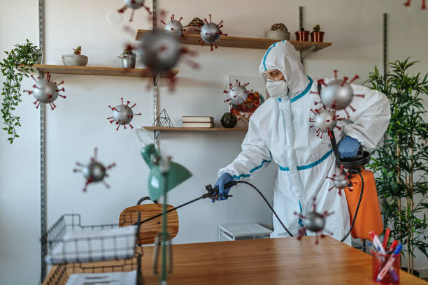 Man in protective suit disinfecting covid-19 molecules