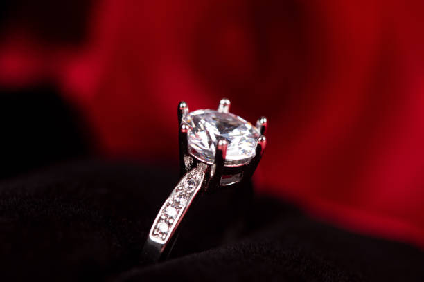 istock Diamond ring in red jewel box with flower background 1264641924