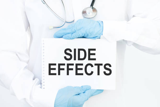istock Side Effects - Medical doctor shows information. Doctor's hands show sheet with text 1264644880