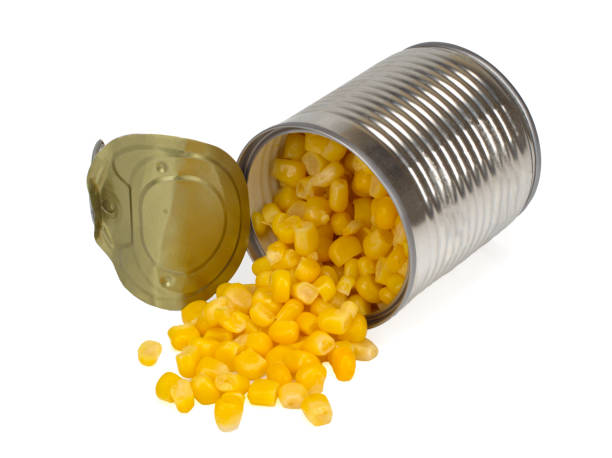 istock sweet corn sprinkled from a metal can isolated on white background, Top view 1264645579