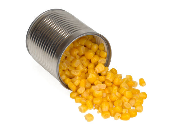 istock sweet corn sprinkled from a metal can isolated on white background, Top view 1264645582