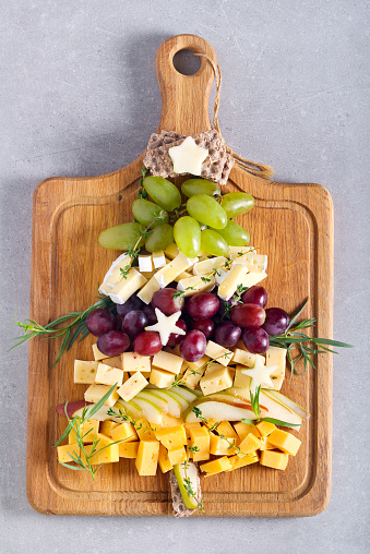 Christmas cheese board – assortment of different cheese and fruits