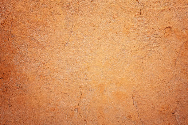 istock Abstract terracotta rustic orange textured background with lots of cracks and character. 1264647013