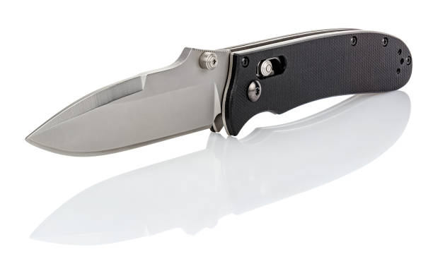 istock Folding pocket knife with open satin blade and textured black composite plastic cover plates on steel handle isolated on white background with reflection on glossy surface. Pocket knife close-up image 1264647699