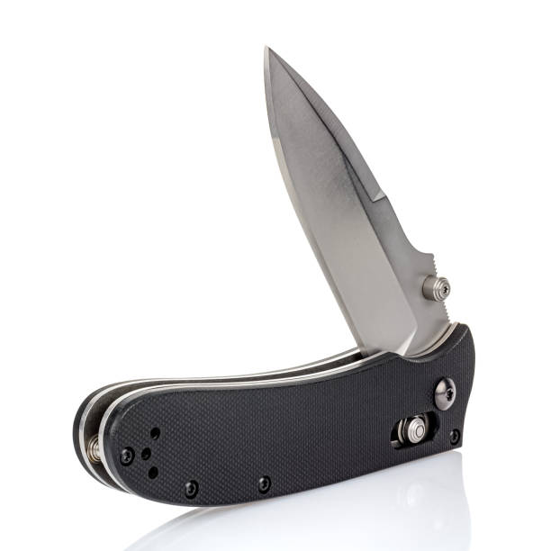 istock Open folding pocket knife with satin blade and textured black composite plastic cover plates on steel handle isolated on white background with reflection on glossy surface. Pocket knife close-up image 1264647706