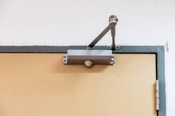 Clean door closers for a private room. Clean door closers for a private room of the manager in the office building. approaching stock pictures, royalty-free photos & images