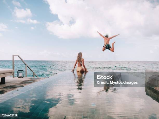 Couple Enjoying Luxury Vacations Stock Photo - Download Image Now - Vacations, Beach, Luxury