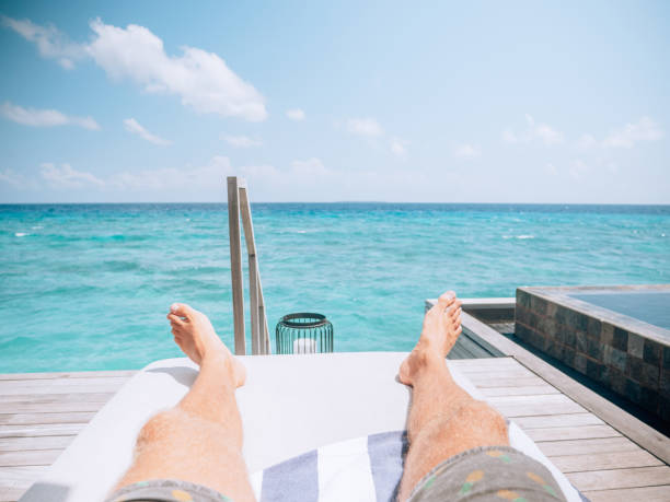 istock Pov of man relaxing on sun deck 1264652429