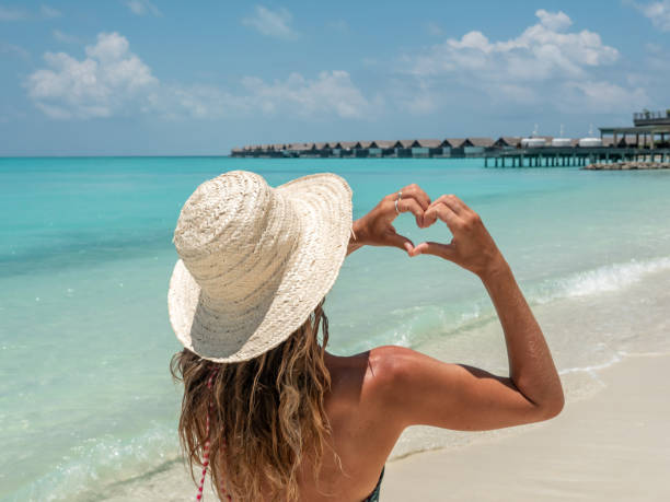 istock Young woman sunbathing on tropical beach loving vacations 1264652995
