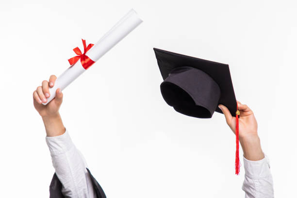 istock Diploma with a red ribbon in hand on white background 1264656440