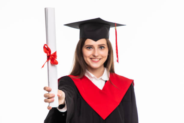 istock Happy graduated student girl with scroll isolated on white background 1264659464