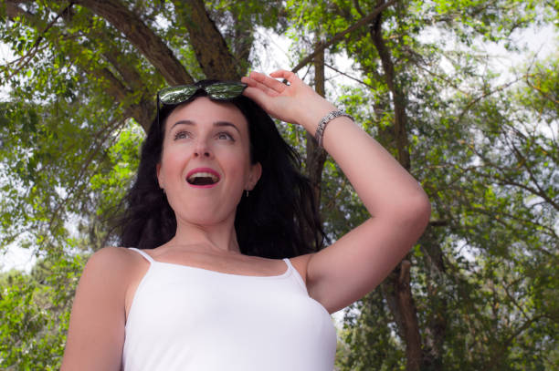 Attractive young girl, dressed in white, discovering and traveling, in nature.