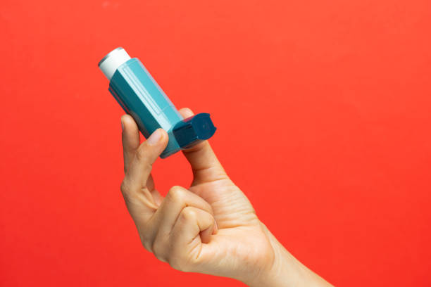 istock Female Hand Holding Green Inhaler 1264669011