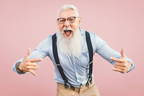 istock Senior man having fun posing in front camera - Happy mature male enjoying retired time - Elderly people lifestyle and hipster culture concept - Pink background 1264670857
