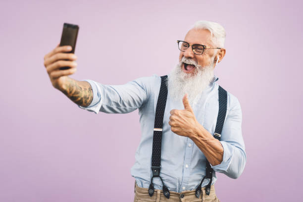 istock Senior man using mobile smartphone and listening to music 1264670914