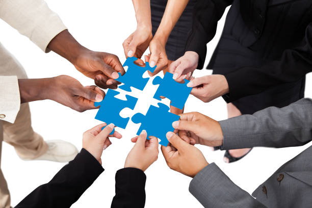 istock Businesspeople Holding Jigsaw Puzzle 1264671118