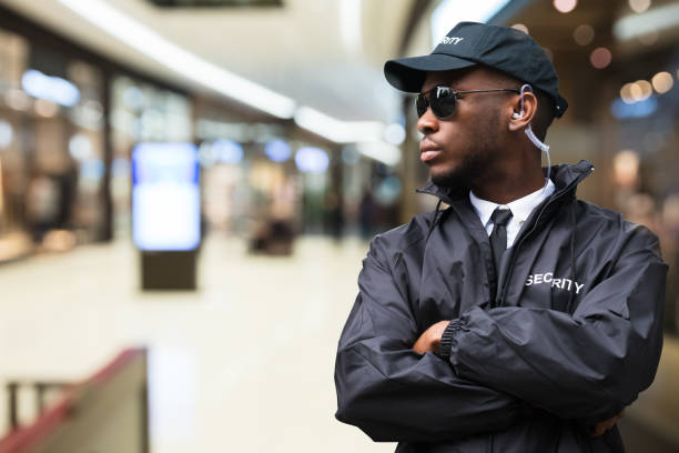 Security Guard In Shopping Mall Security Guard Officer Standing In Shopping Mall security staff stock pictures, royalty-free photos & images