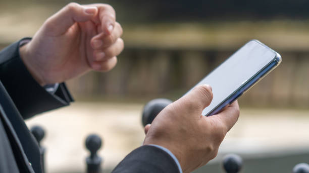 istock Finger of businessman using smartphone application 1264674248