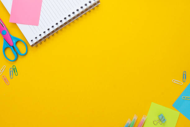 istock Education development concept. Back to school. Yellow background withschool supplies, notebook, rocket and sticky notes. Mock up. Top view. 1264675570