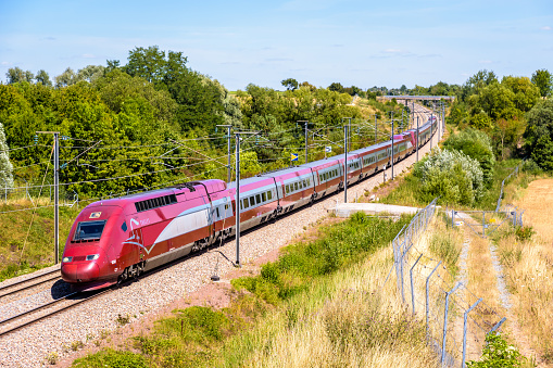 Ver-sur-Launette, France - July 29, 2020: A Thalys PBKA high speed train is driving from Brussels to Paris on the LGV Nord, the North European high speed railway line, in the french countryside.
