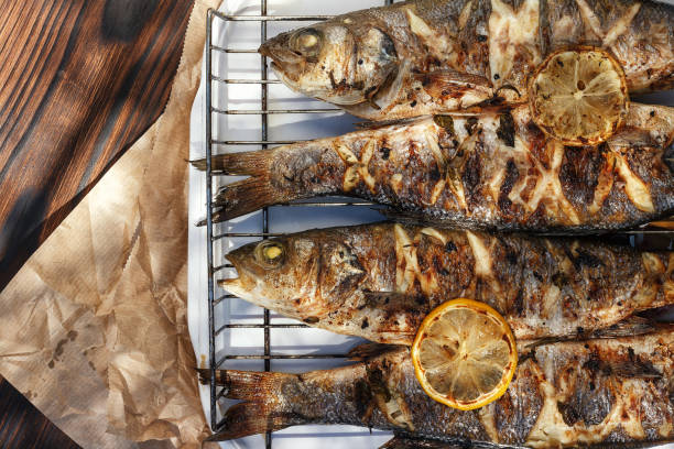 istock Sea Bass fish cooked on coals in a grill 1264678018