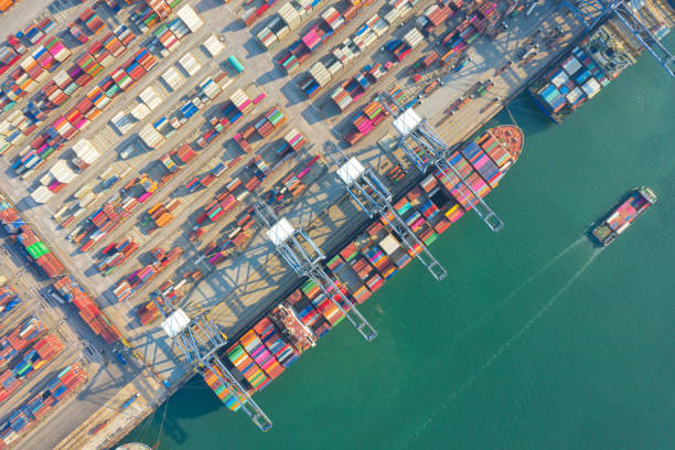 istock Container , container ship in export and import business and logistics. Shipping cargo to harbor by crane. Water transport International. Aerial view and top view 1264678823
