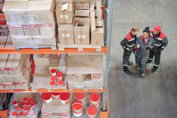 istock Young mixed-race female warehouse worker with digital tablet making presentation 1264679466