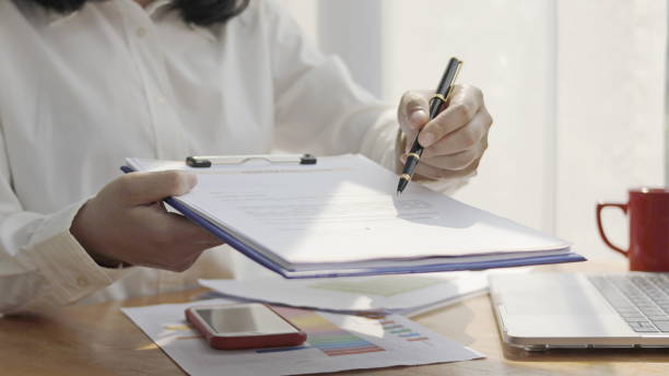 istock business man's hand has a pen 1264681178