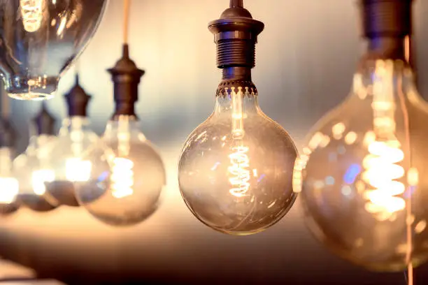 Photo of close up modern pendant light with vintage light bulb