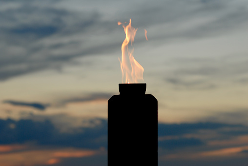 Standing, burning match on a light background