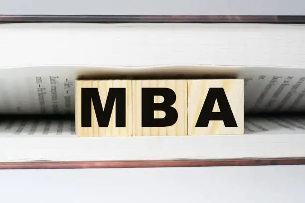 Photo of MBA a word made from building blocks in a book