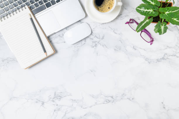 istock Pencil on blank notebook with laptop and black coffee on marble table background, 1264685150
