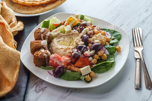 Loaded salad Greek falafel hummus plate with pita bread