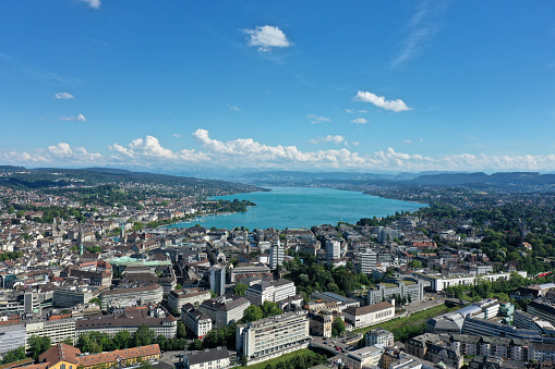 The Skyline of Zurich City with several office buildings and the beautiful lake zurich in the background. The image was captured during summer season.